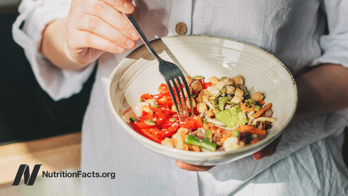 Person eating plant-based meal out of a bowl