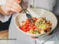 Person eating plant-based meal out of a bowl
