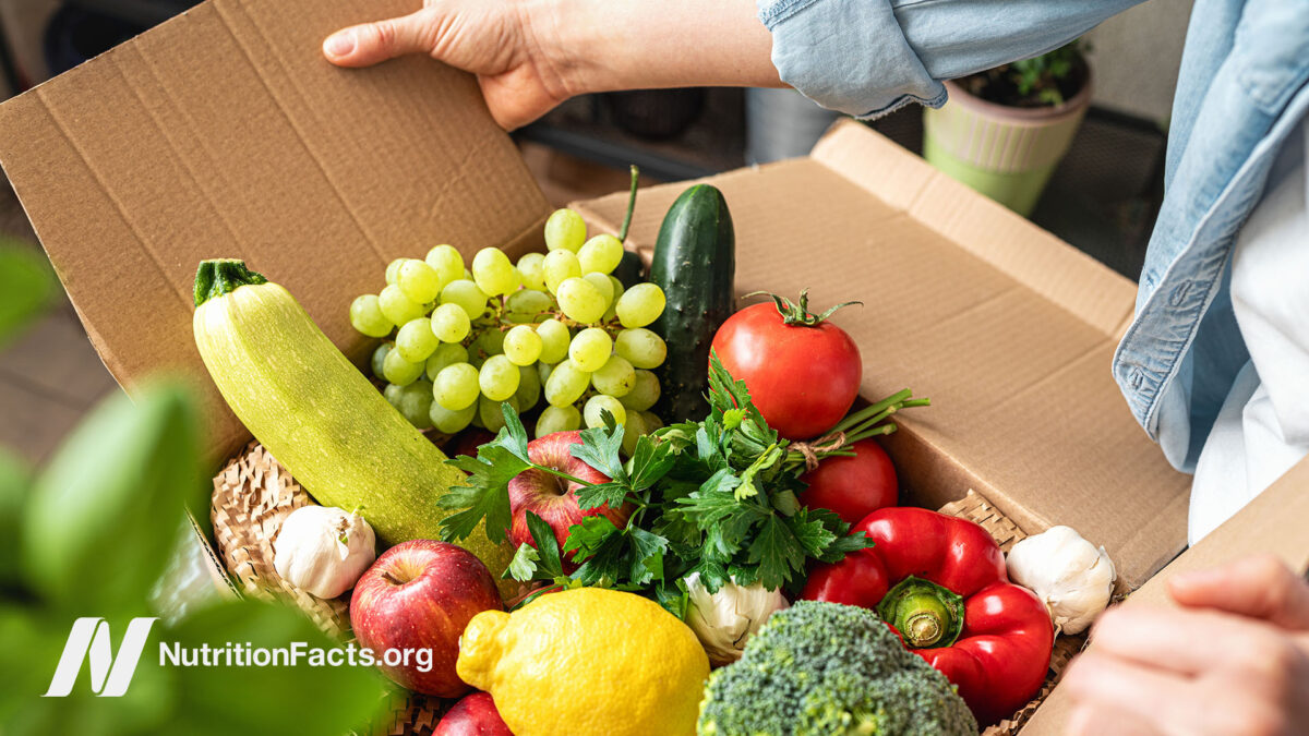 Person opening a box of fresh produce