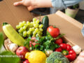 Person opening a box of fresh produce
