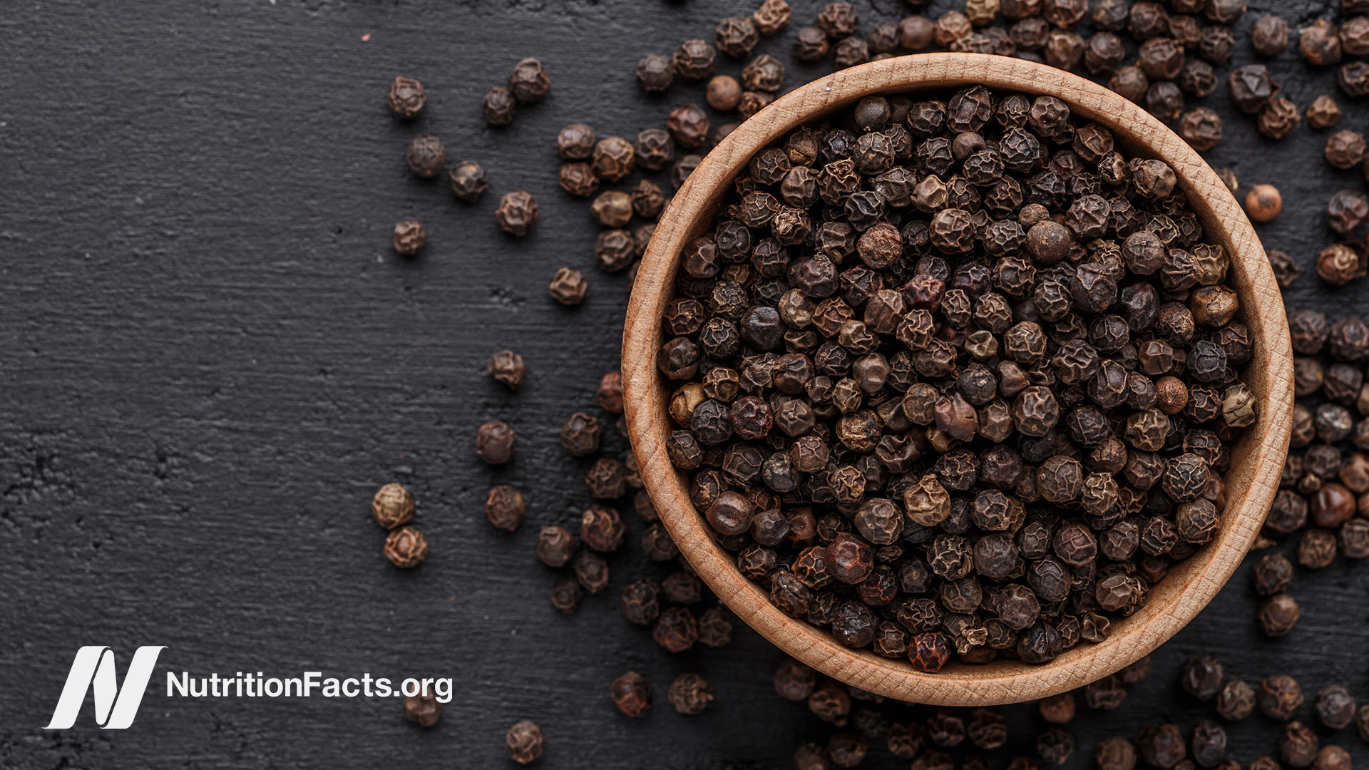 Bowl of whole black peppercorns