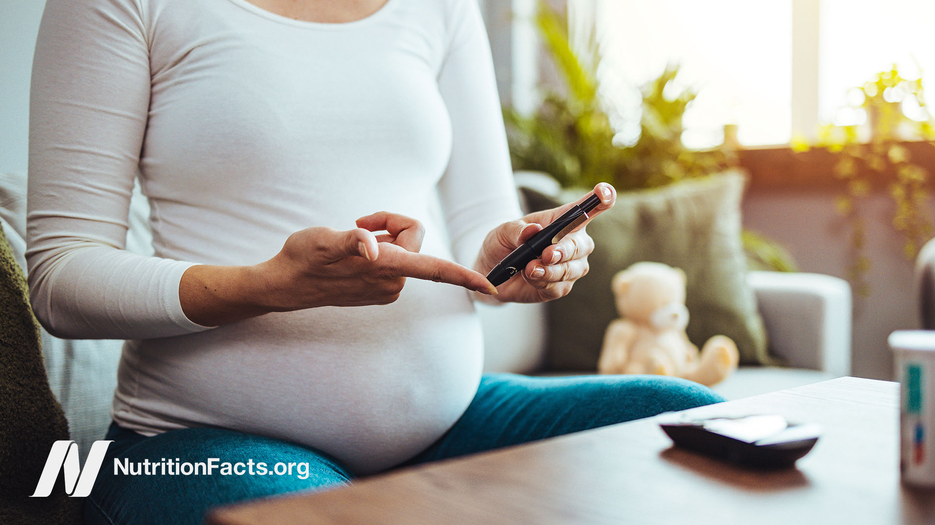 Diabetic pregnant person using a blood glucose meter