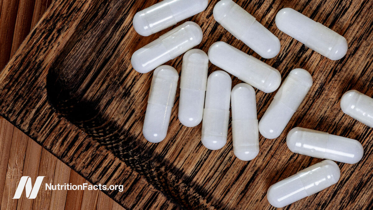 Wooden tray filled with taurine supplement capsules