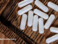 Wooden tray filled with taurine supplement capsules
