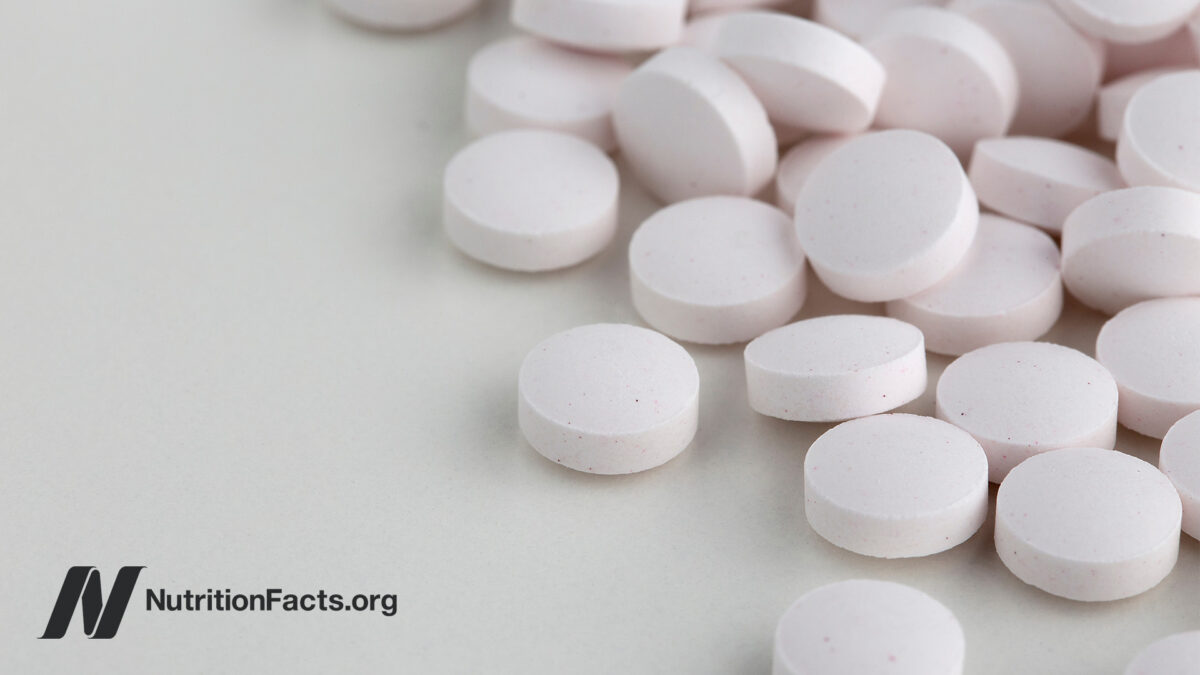 a bunch of white vitamin B12 tablets on a white table