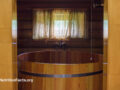 Outside view of an open wooden door looking into a wooden cold plunge tub