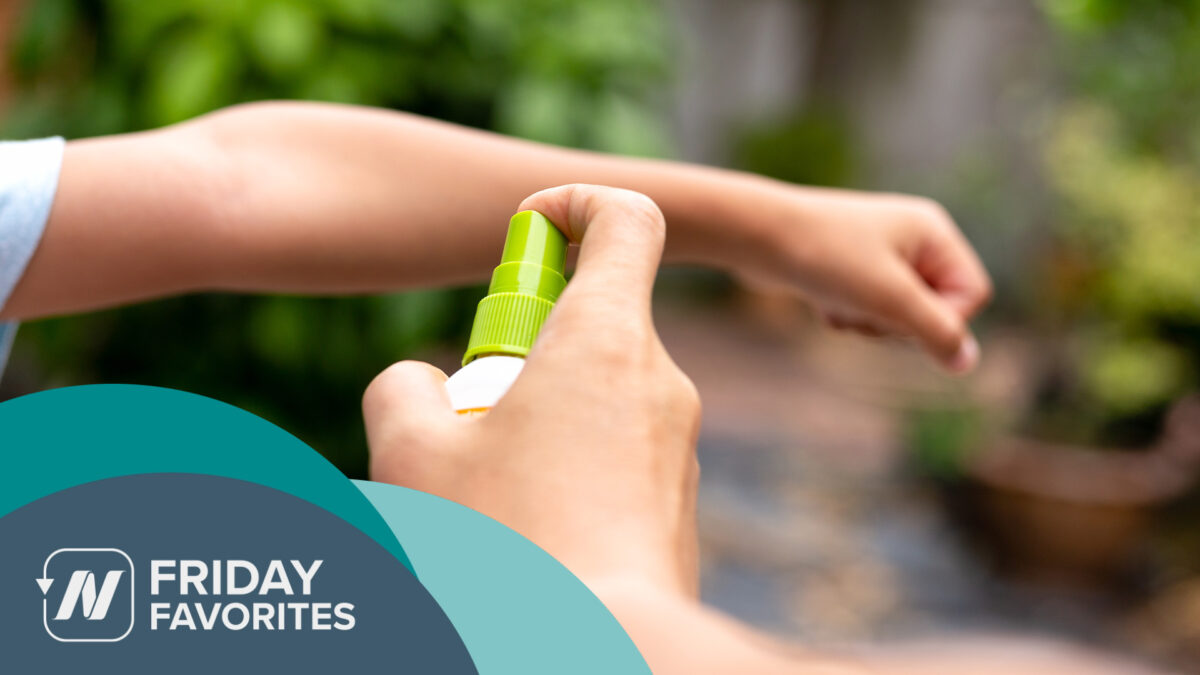 a person spraying mosquito repellent on their arm
