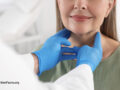 woman having a neck exam