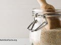 A wooden scoop reaching into a jar of fiber-rich food