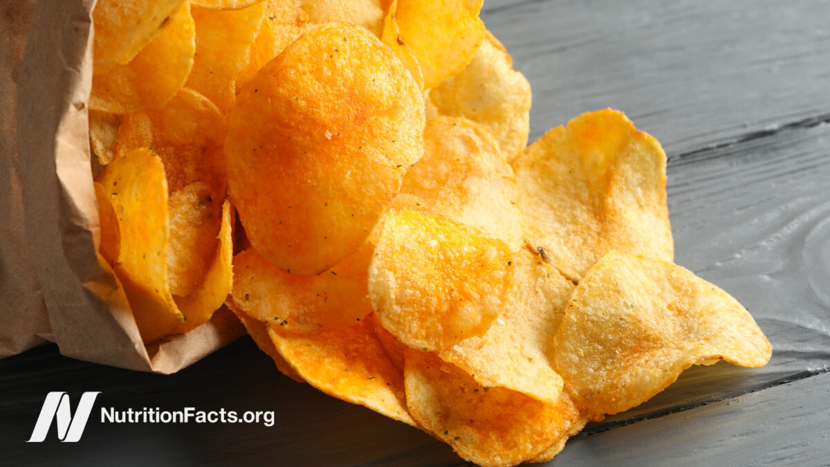 Potato chips spilling from a paper bag