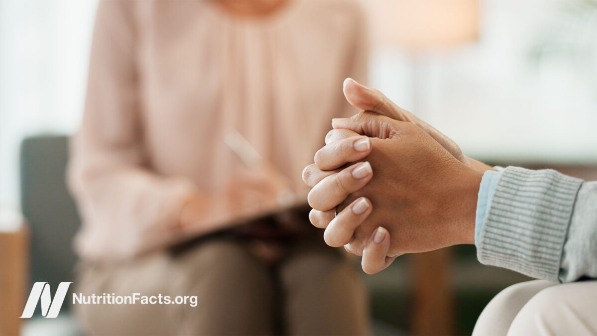 Close up of clasped hands of a therapy patient