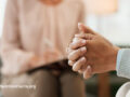 Close up of clasped hands of a therapy patient
